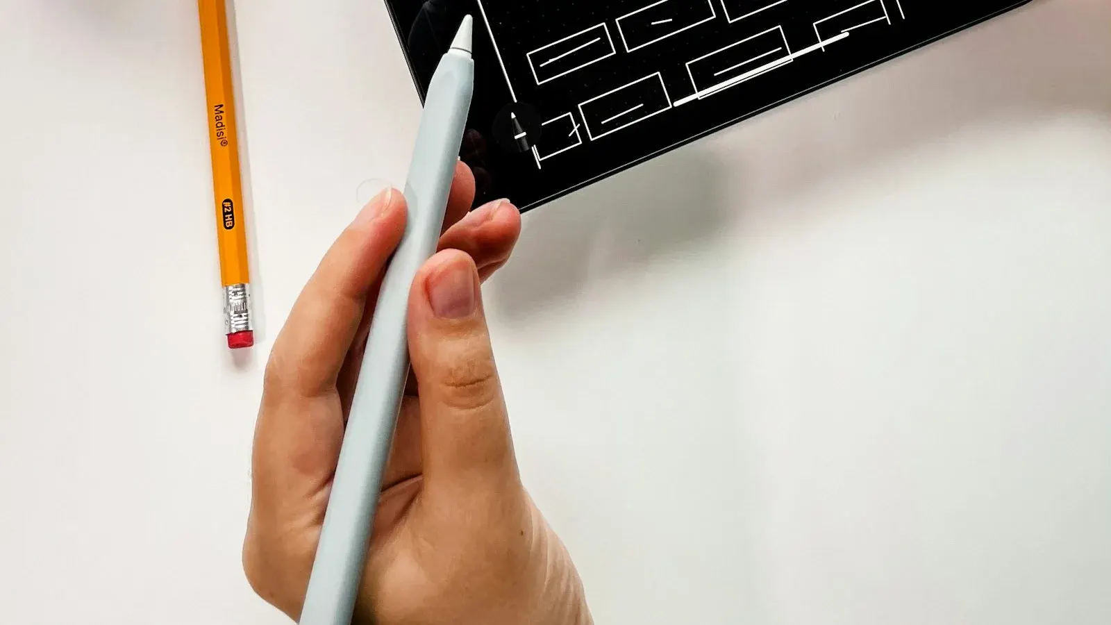 Tablet showing a page design to compare Elementor, Gutenberg and Divi