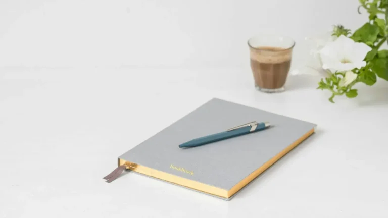 Notebook and pen for writing a website brief