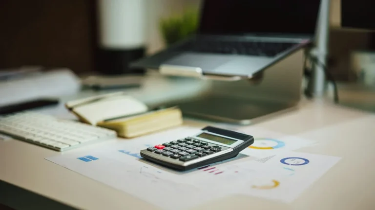 Calculator and laptop for planning a WordPress website budget