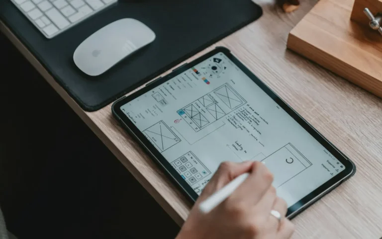 Stylus sketching a page layout on a tablet for a WPBakery website